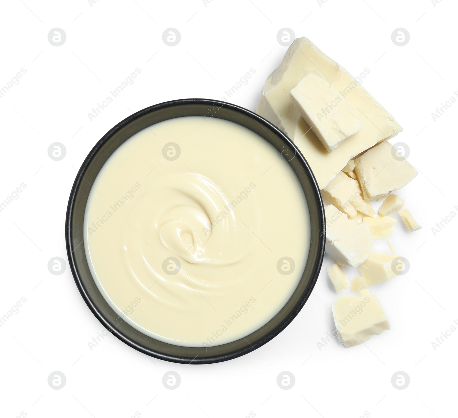 Photo of Tasty chocolate paste in bowl and pieces isolated on white, top view