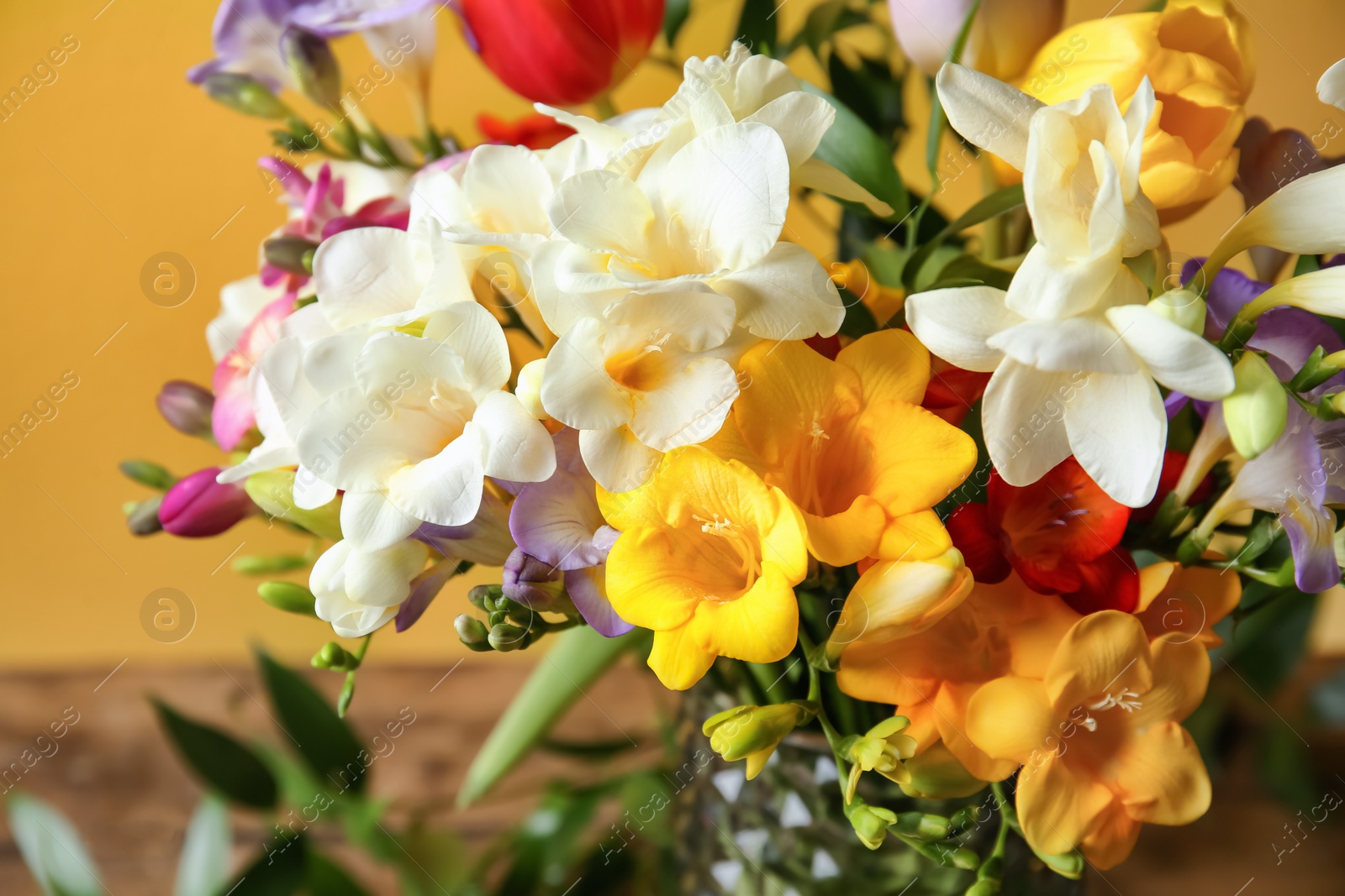 Photo of Beautiful bouquet of freesia flowers, closeup