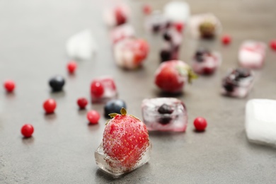 Photo of Different frozen berries on gray table