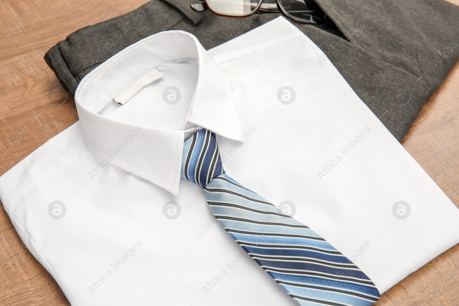 Photo of School uniform for boy on wooden background