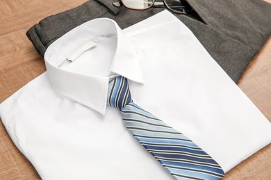 Photo of School uniform for boy on wooden background