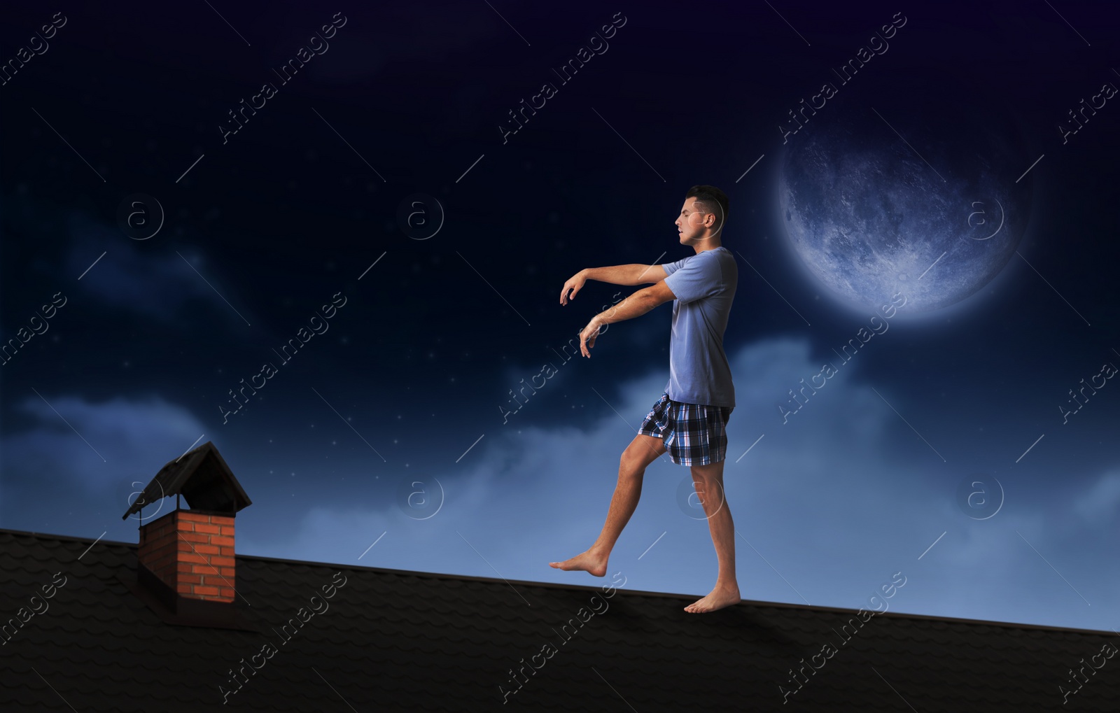 Image of Sleepwalker wearing pajamas on roof in night