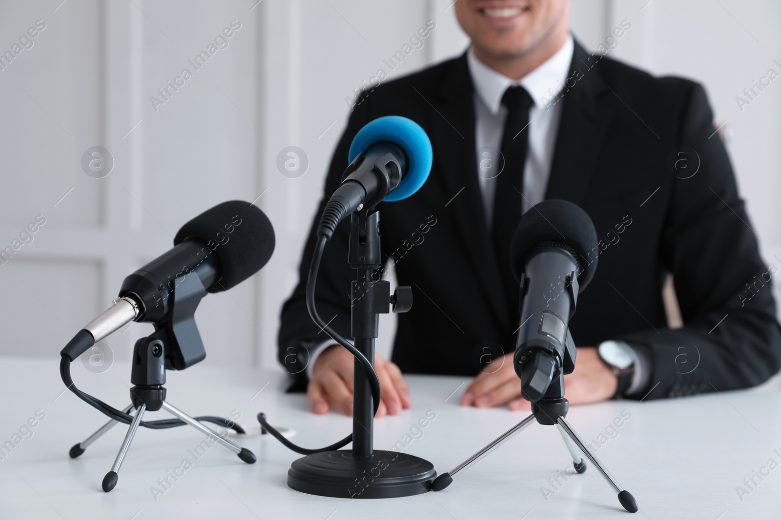 Photo of Business man giving interview at official event, closeup