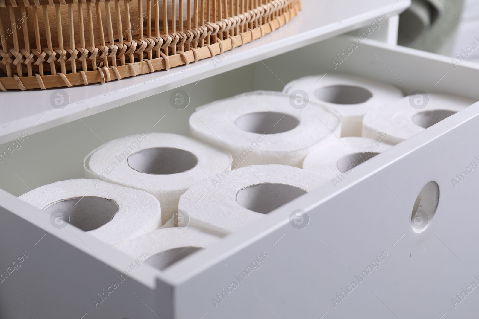 Photo of Many toilet paper rolls in white drawer indoors