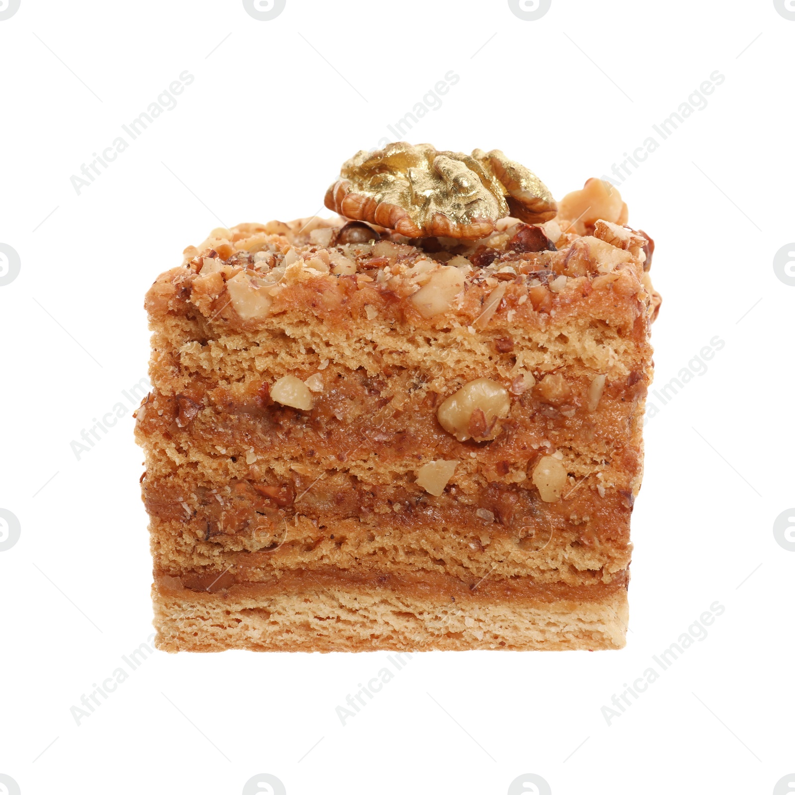 Photo of Delicious honey cake decorated with golden walnut isolated on white