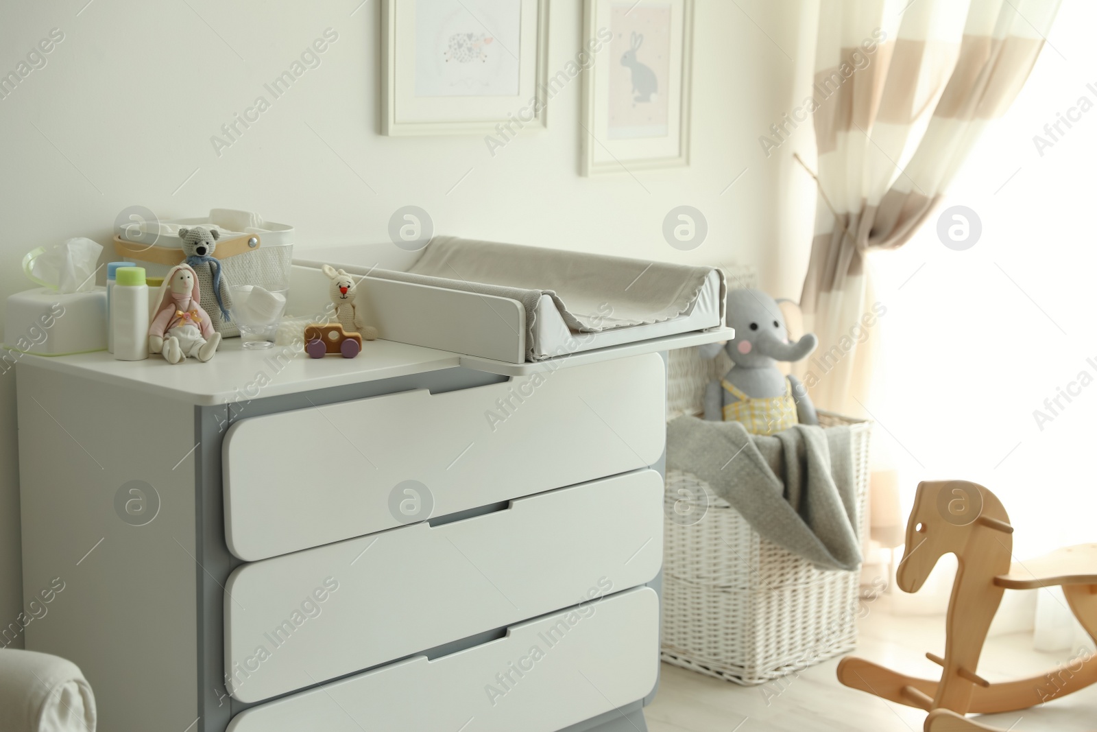 Photo of Modern changing table in baby room interior