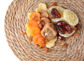 Photo of Wicker mat with different tasty dried fruits on white background, top view