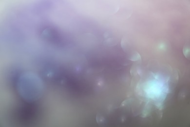 Photo of Blurred view of shiny lights on light background. Bokeh effect