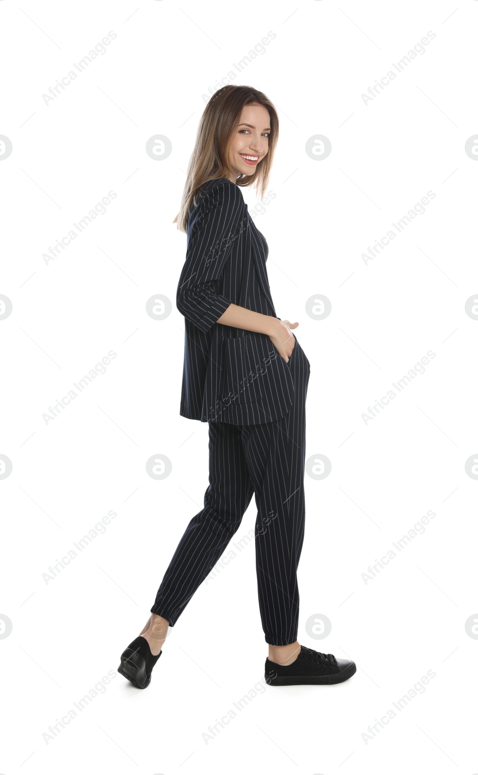 Photo of Full length portrait of beautiful young woman in fashionable suit on white background. Business attire