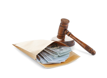 Envelope with dollar bills and gavel isolated on white. Bribe concept