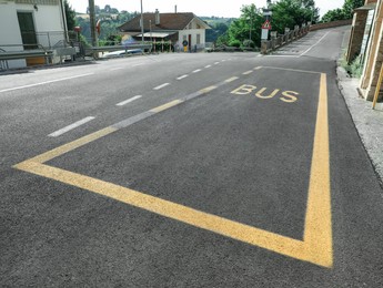 Bus stop pad on asphalt road on sunny day