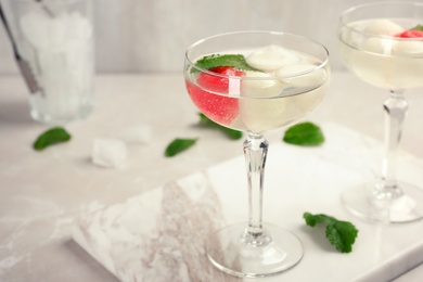 Photo of Glasses with tasty melon and watermelon ball drinks on light table