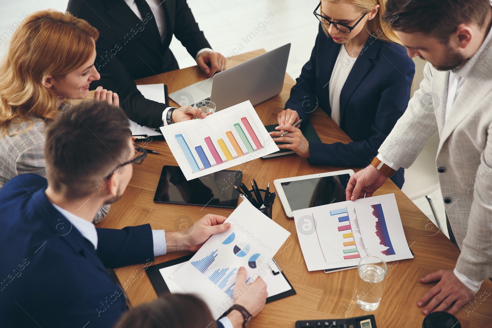 Photo of Businesspeople having meeting in office. Management consulting