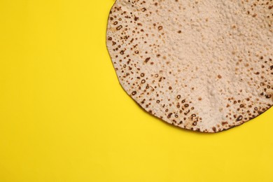 Tasty matzo on yellow background, top view with space for text. Passover (Pesach) celebration