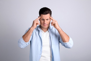 Photo of Portrait of stressed man on light background