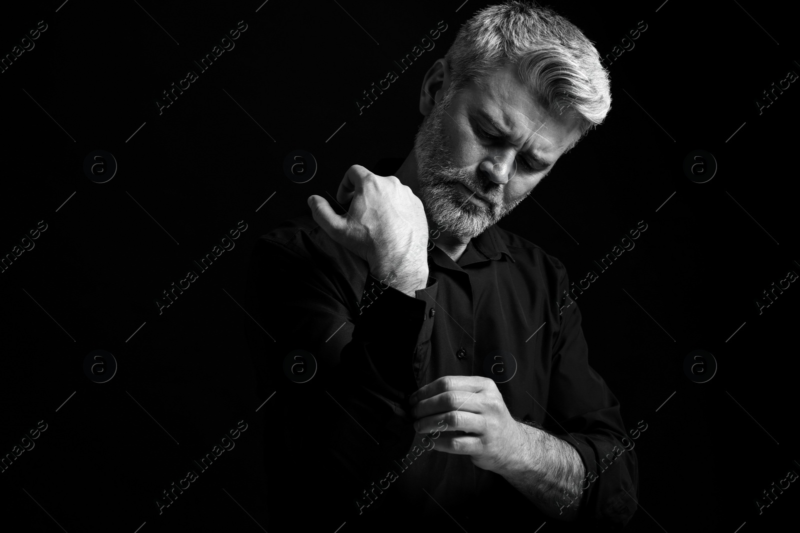 Photo of Portrait of handsome man on dark background. Black and white effect