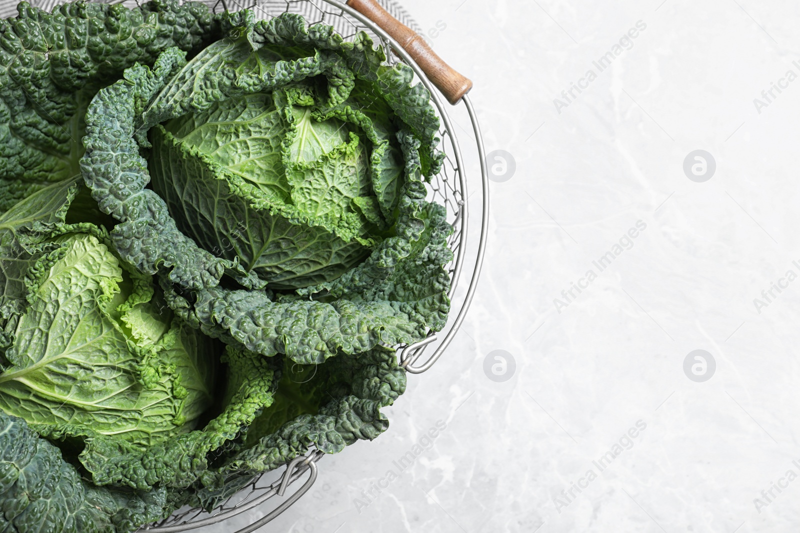 Photo of Fresh green savoy cabbages on marble table, top view. Space for text