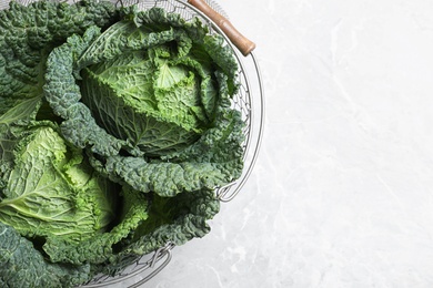 Fresh green savoy cabbages on marble table, top view. Space for text