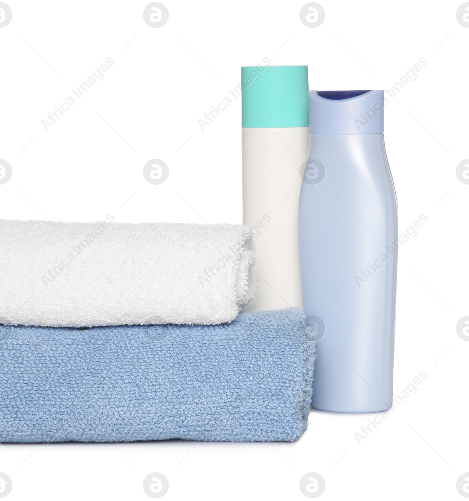 Photo of Soft terry towels with cosmetic products on white background