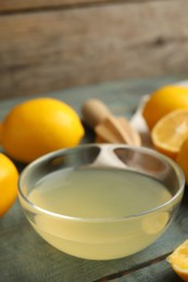 Photo of Freshly squeezed lemon juice in glass bowl on table