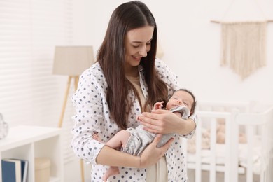 Photo of Mother with her cute newborn baby at home