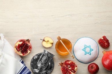 Photo of Flat lay composition with Rosh Hashanah holiday attributes on white wooden table. Space for text