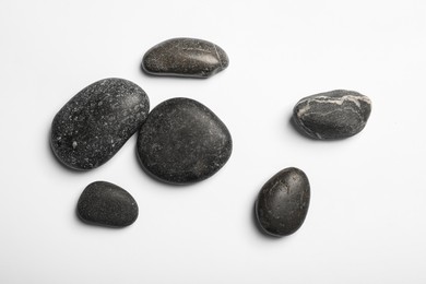 Many different stones on white background, top view