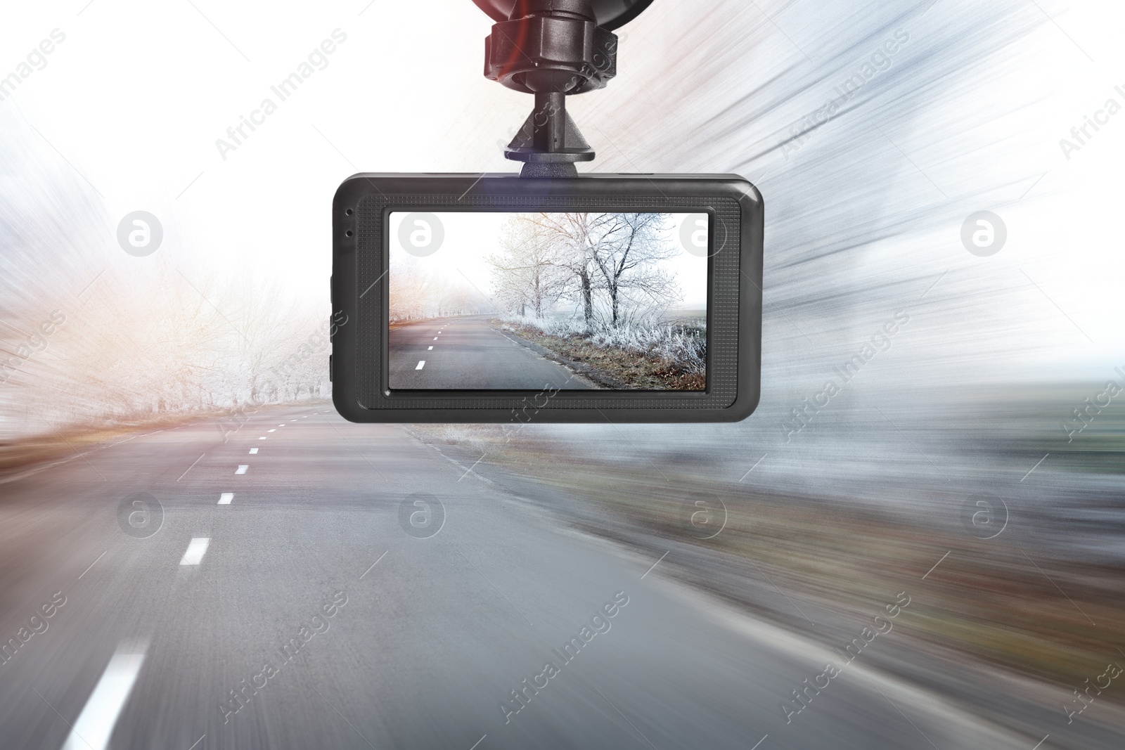 Image of Modern dashboard camera mounted in car, view of road during driving