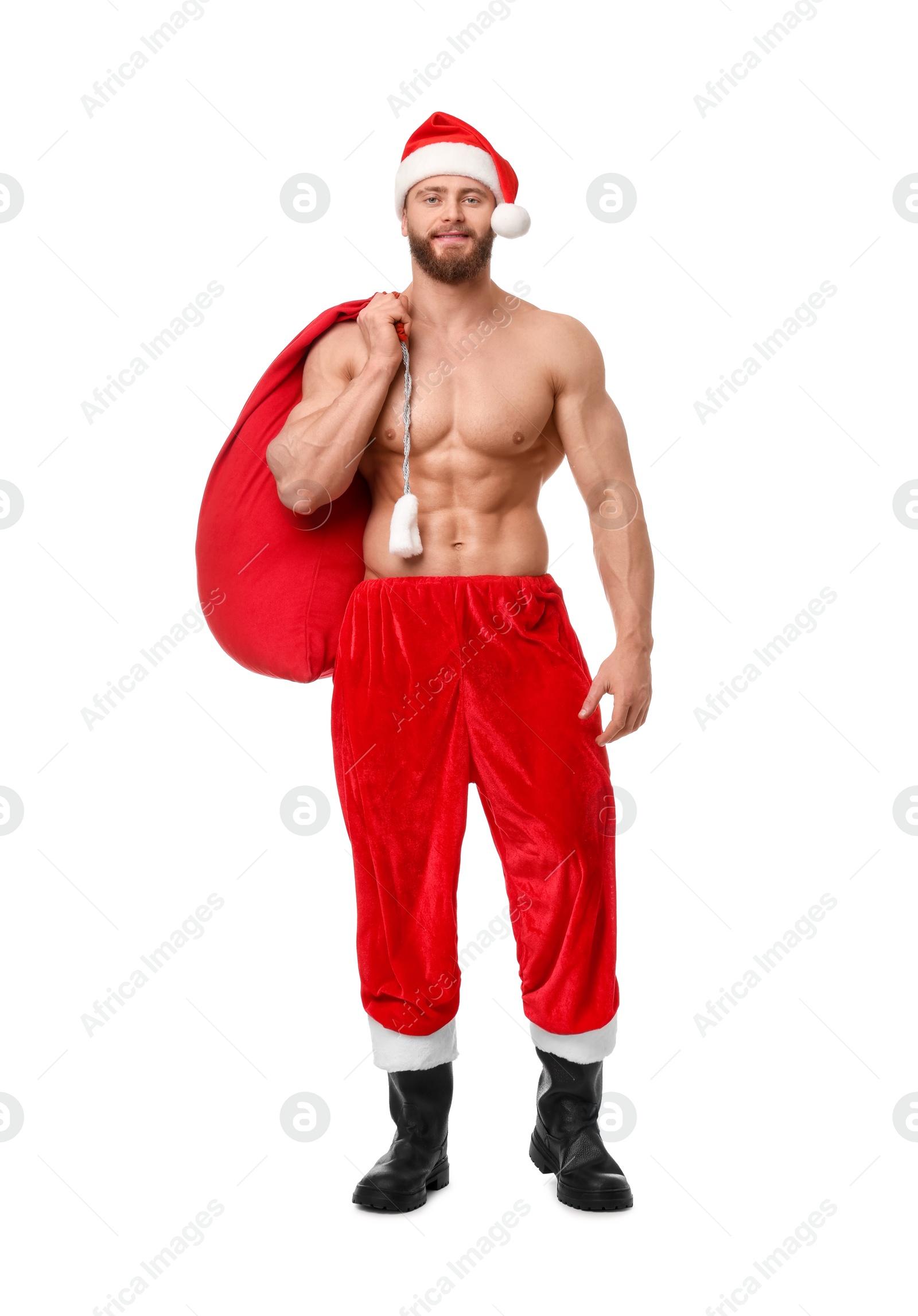 Photo of Muscular young man in Santa hat holding bag with presents on white background