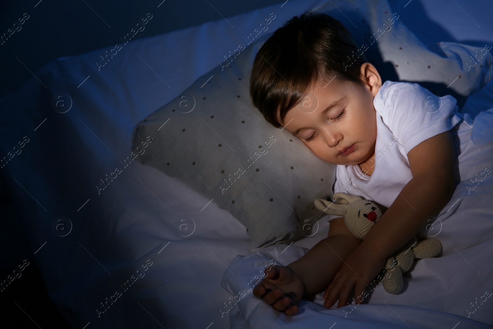 Photo of Cute little baby sleeping with toy at home. Bedtime