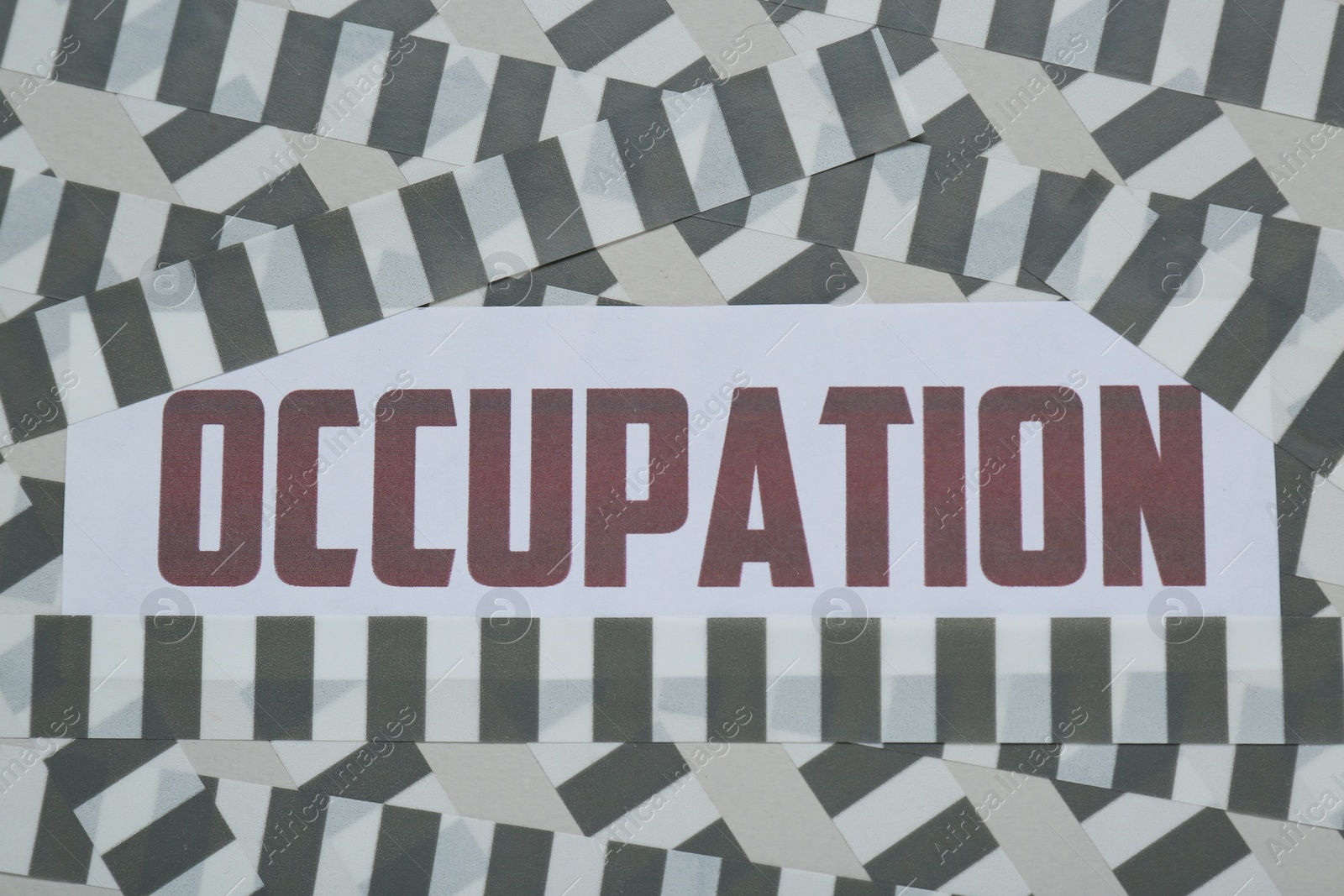 Photo of Word Occupation attached with adhesive tape on light background, top view