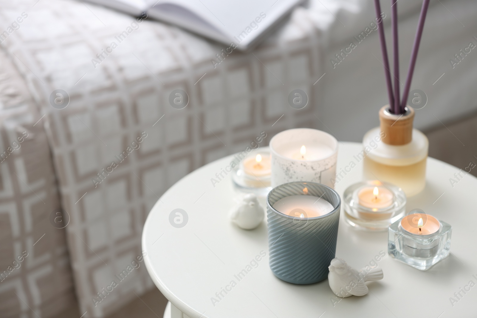 Photo of Beautiful burning candles on table at home
