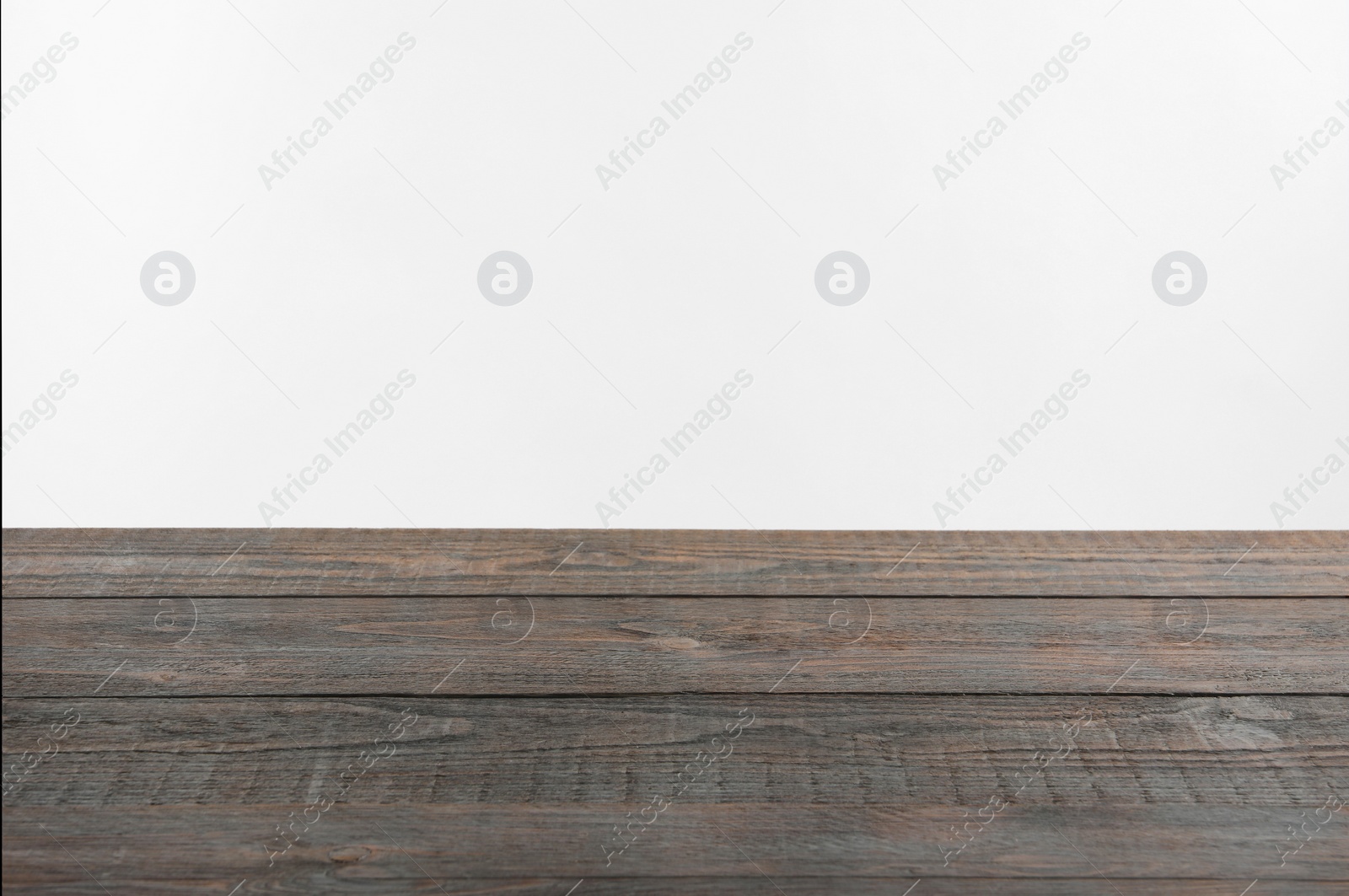 Photo of Empty wooden surface on white background. Space for text