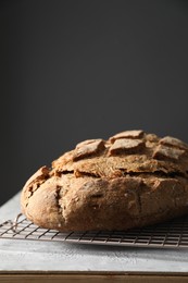 Photo of Freshly baked sourdough bread on grey table. Space for text