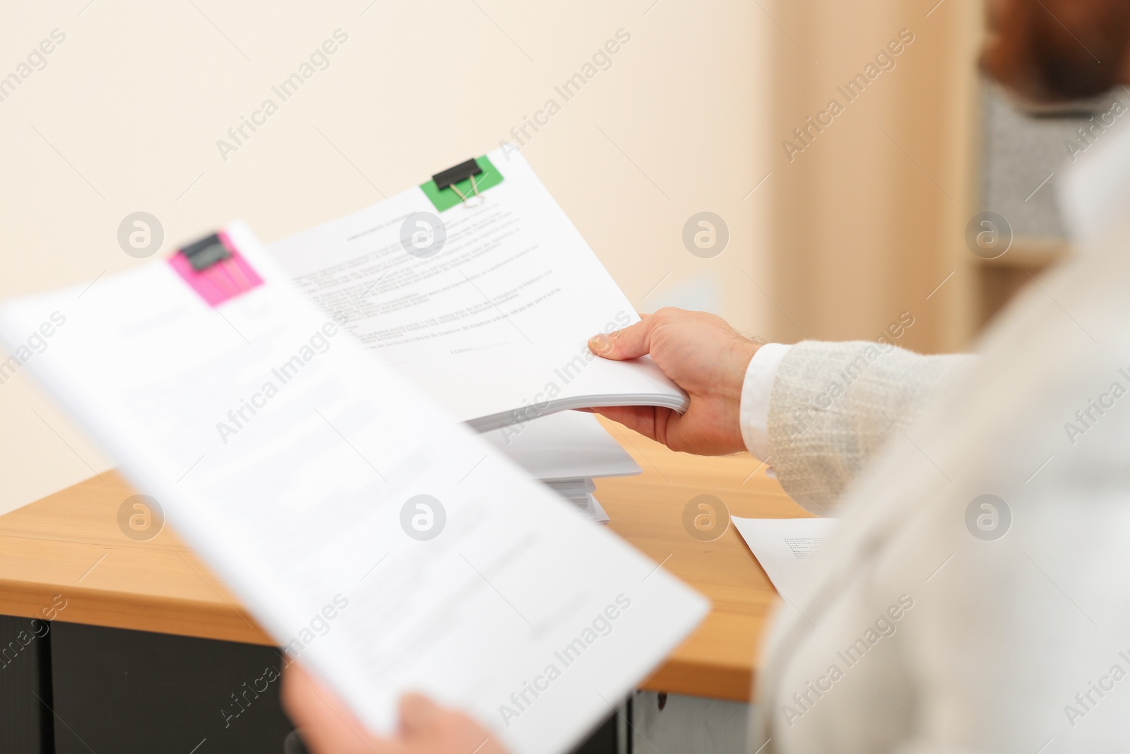 Photo of Man working with documents in office, closeup