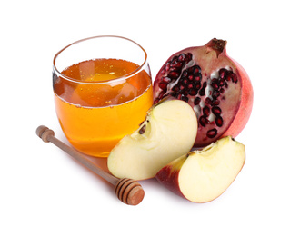 Photo of Honey, apple slices and pomegranate on white background. Rosh Hashanah holiday