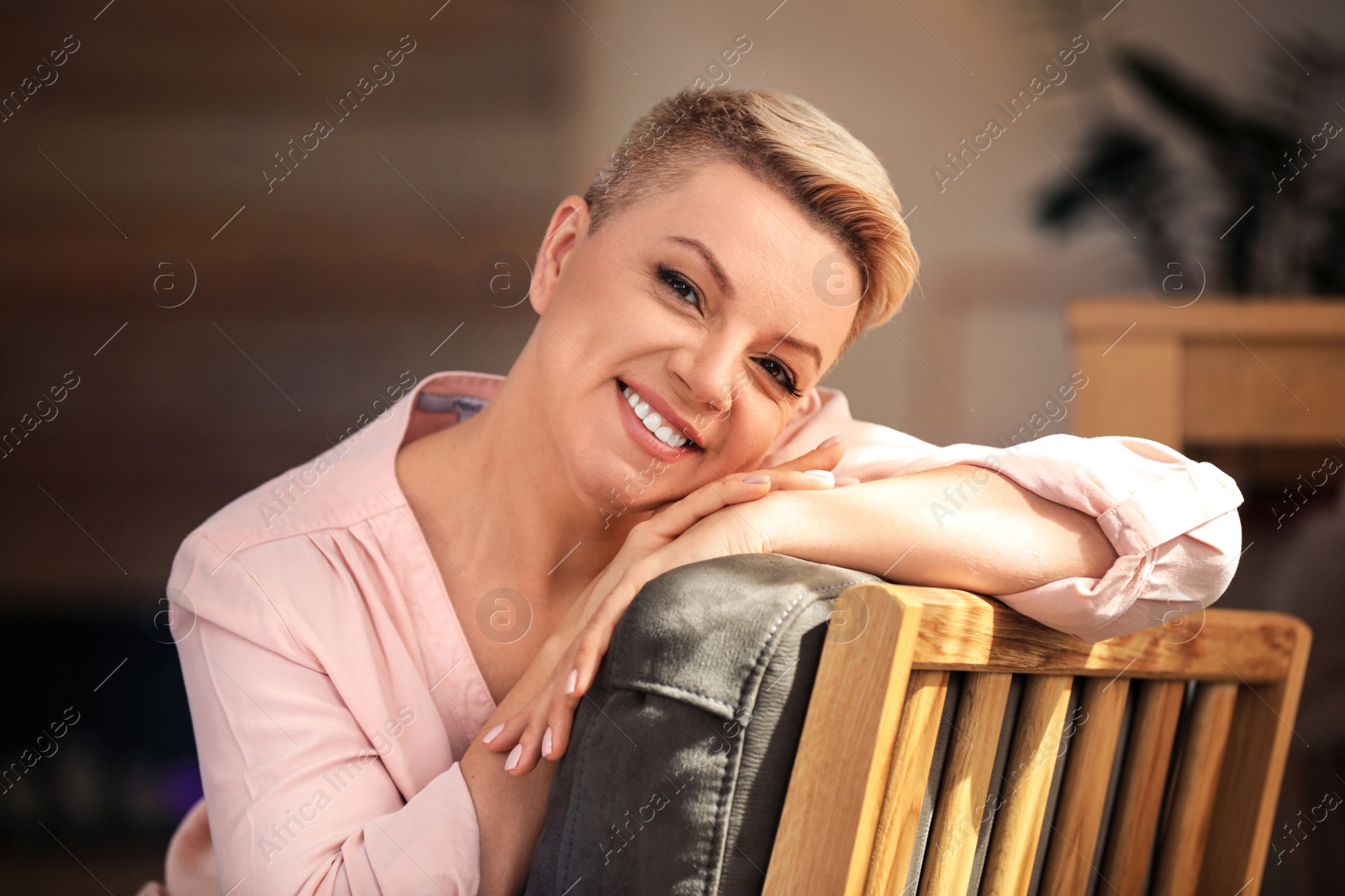 Image of Portrait of beautiful happy woman at home