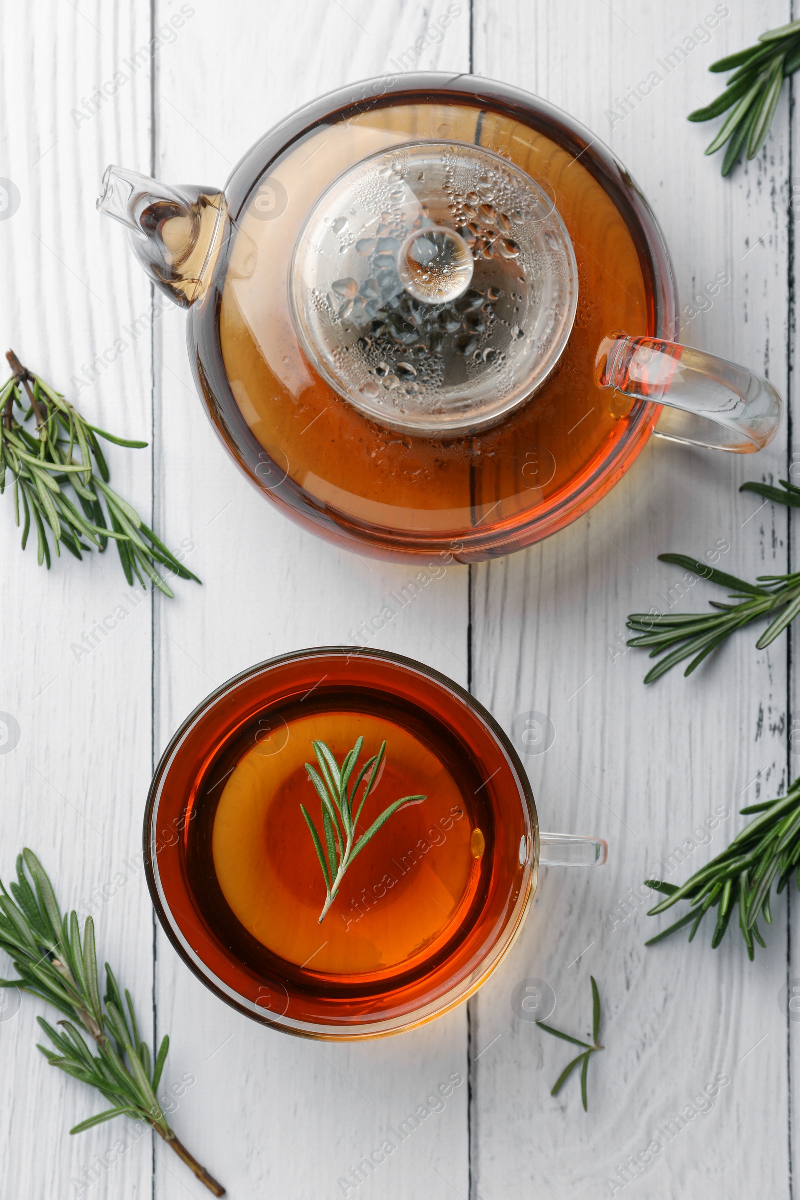 Photo of Aromatic herbal tea with rosemary on white wooden table, flat lay