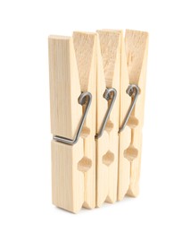 Three classic wooden clothespins on white background