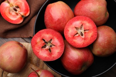 Photo of Tasty apples with red pulp on wooden table, flat lay