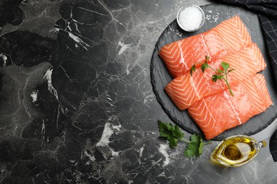 Photo of Flat lay composition with fresh raw salmon on black marble table, space for text. Fish delicacy