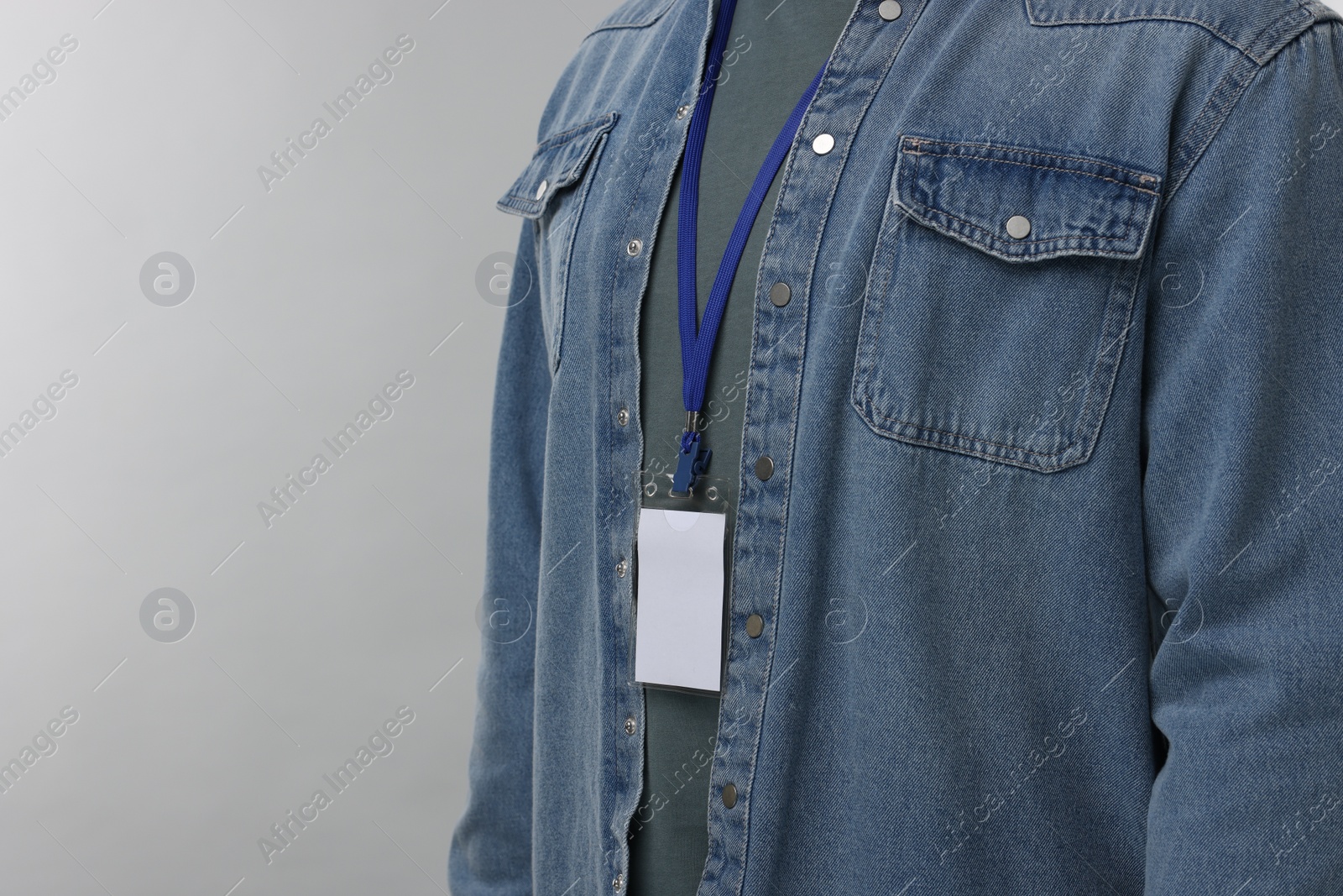 Photo of Man with blank badge on grey background, closeup. Space for text