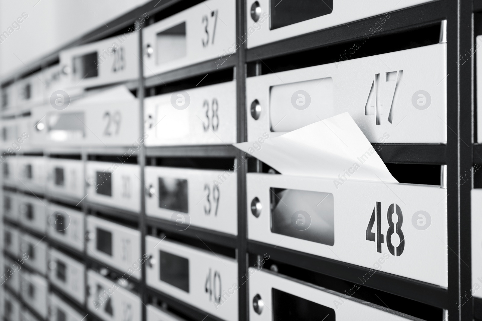 Photo of New mailboxes with keyholes, numbers and receipts, closeup