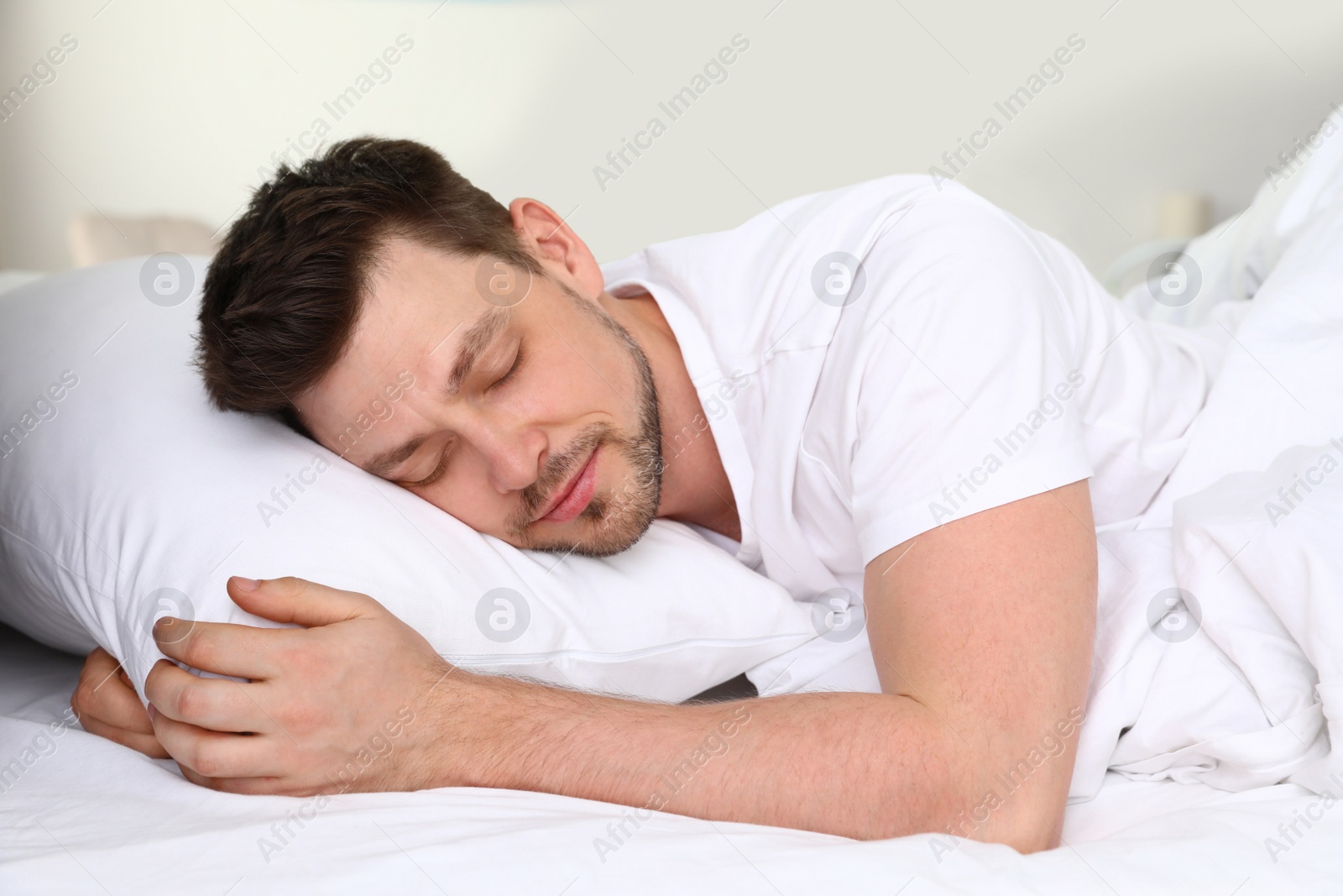 Photo of Handsome man sleeping on pillow at home. Bedtime