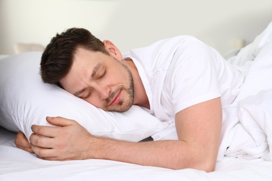 Handsome man sleeping on pillow at home. Bedtime