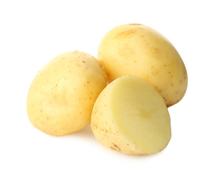 Photo of Whole and cut fresh raw organic potatoes on white background