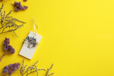 Flat lay composition with scented sachets on yellow background, space for text