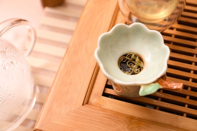 Photo of Ceramic filter for traditional tea ceremony on wooden stand