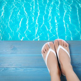 Image of Woman wearing stylish flip flops near swimming pool, top view