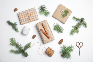 Photo of Composition with Christmas tree branches and gift boxes on white background